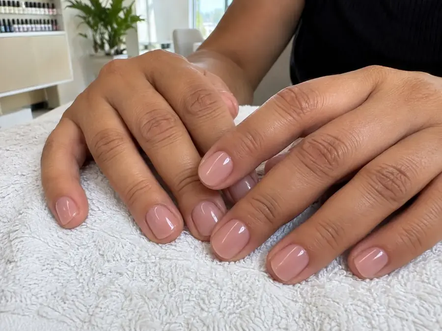 Unhas das mãos cuidadas e esmaltadas em tom natural